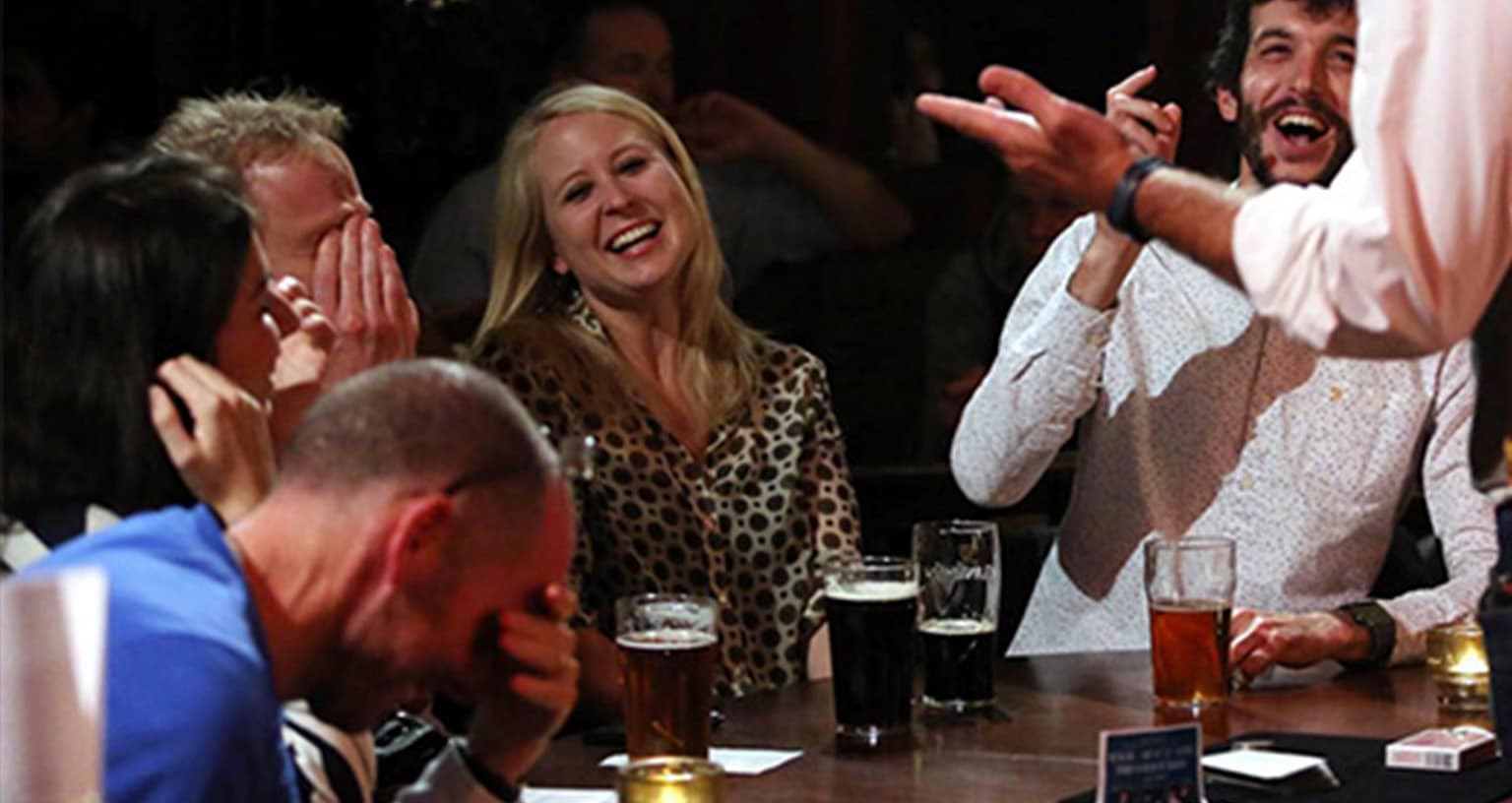 Close-up magician performing sleight of hand at a London drinks reception