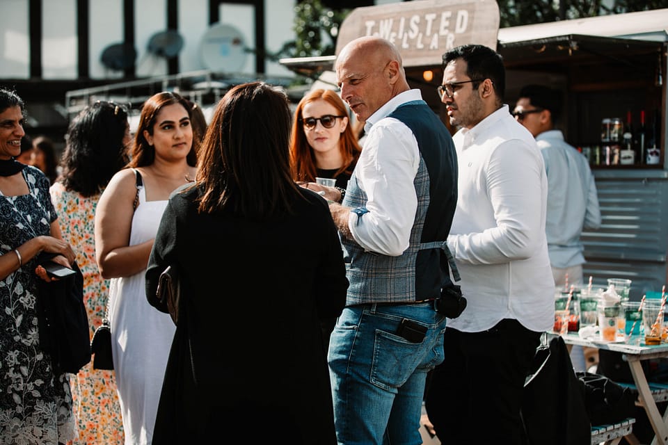 Planning a summer party - Roberto forzoni entertaining a group of people