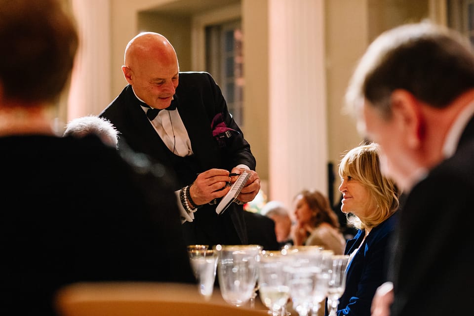 Roberto Forzoni performing close-up magic as party entertainment for guests at a black-tie December event in London