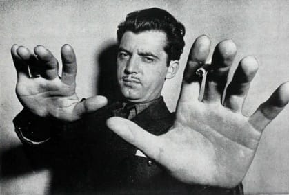 Theodore Annemann, hands outstretched towards the camera in his famous portrait