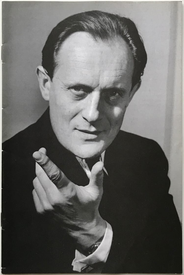 Chan Canasta gesturing during a performance, hand raised to camera